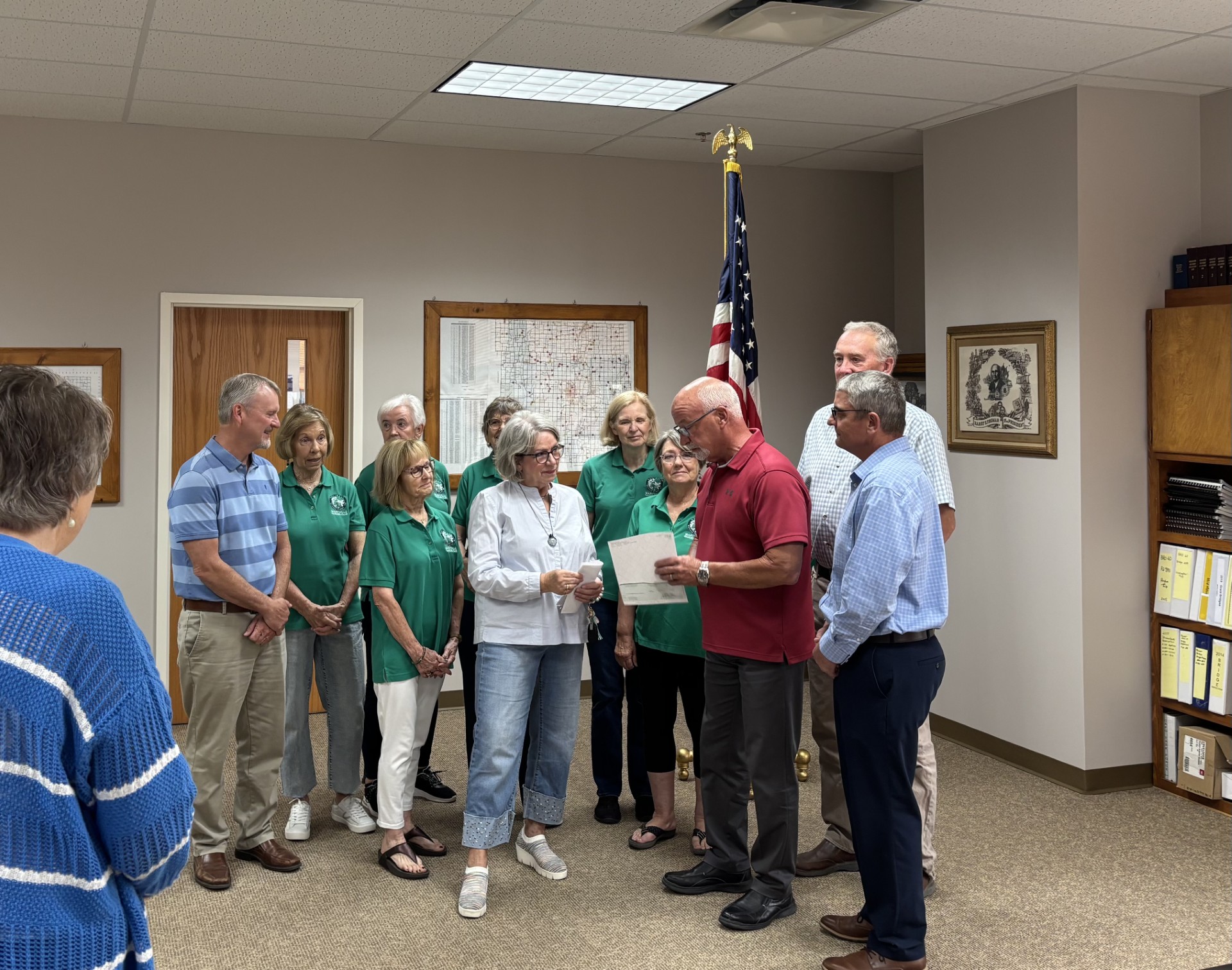 Billy Mackie, center, accepts the donation from Commissioner Bill Walker. 