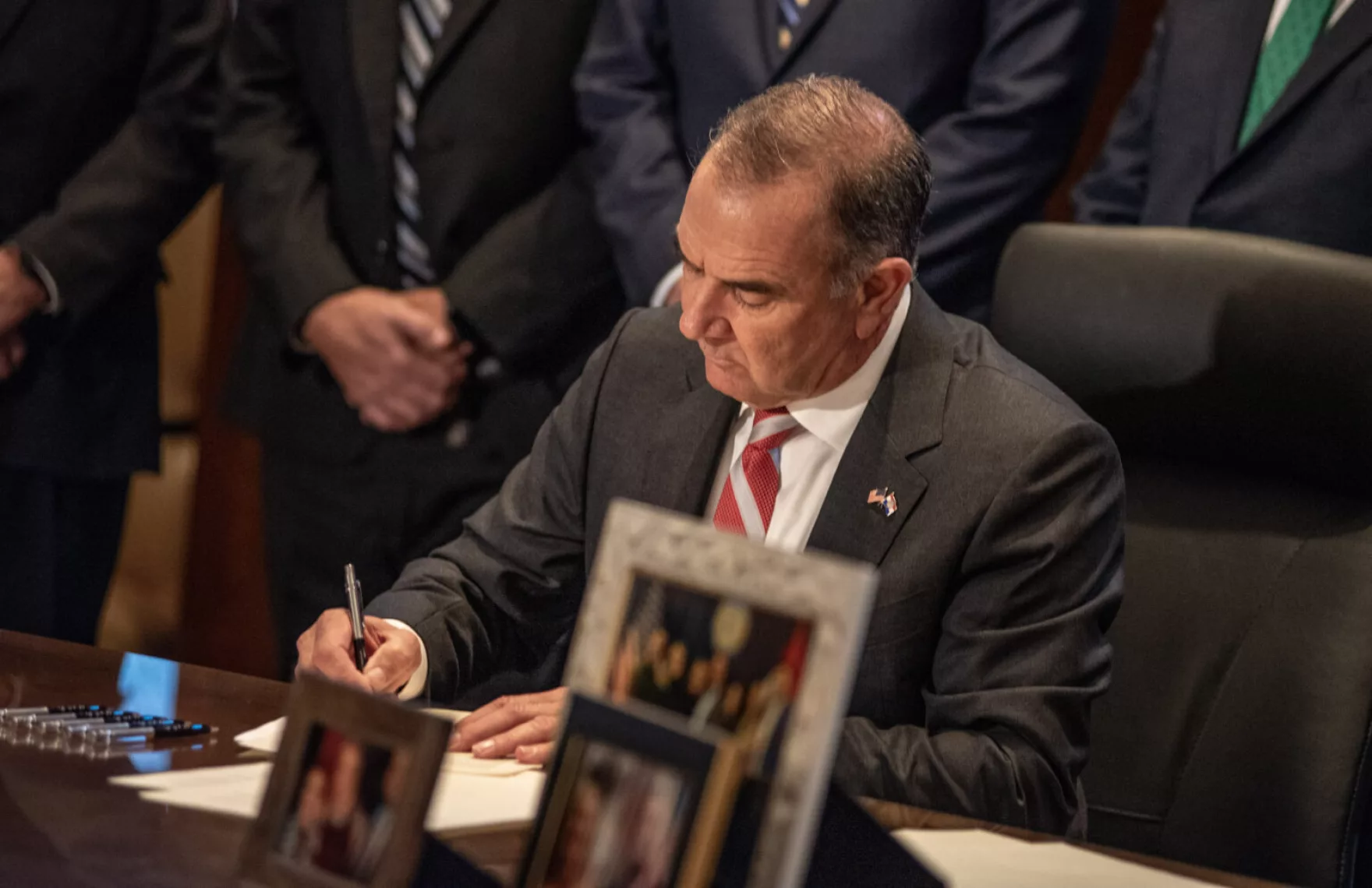 Gov. Mike Kehoe signs his first executive orders following his inauguration ceremony Monday, Jan. 13, 2025.