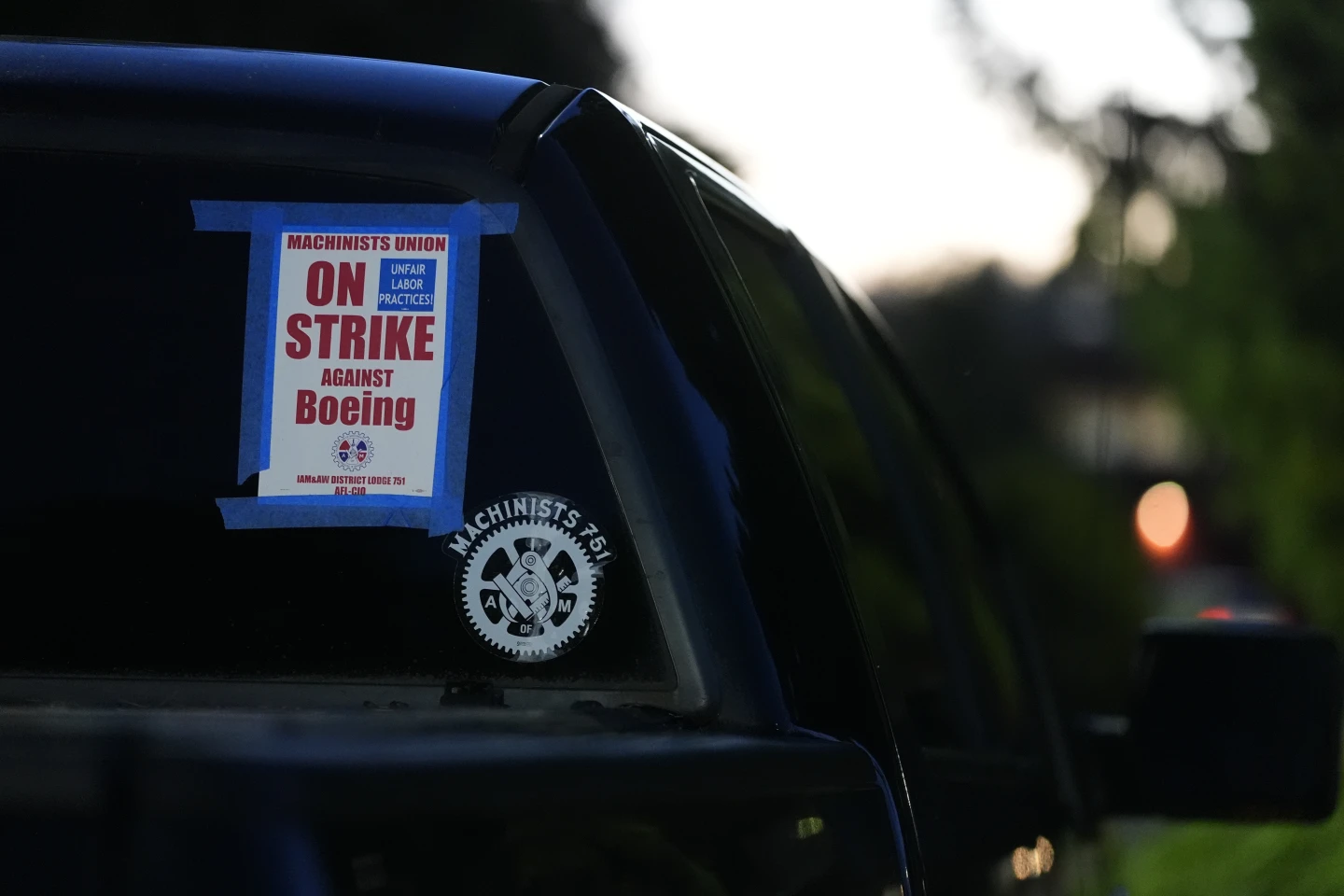 A truck displays a small strike sign in the parking lot of the Areospace Machinists Union hall as Boeing employees arrive to vote on a new contract offer from the company, nov. 4, 2024, in Renton, Wash. (AP Photo/ Lindsey Wasson, file)