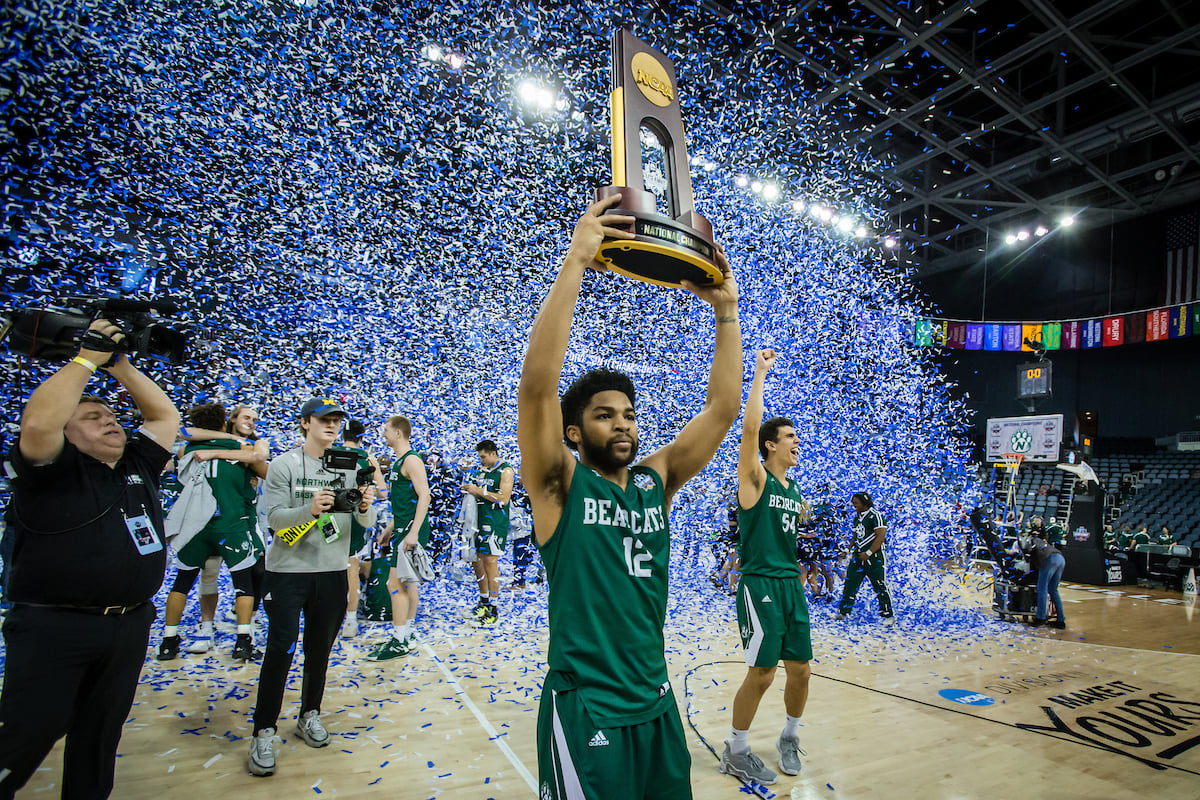 Trevor Hudgins hoists his 3rd national championship trophy